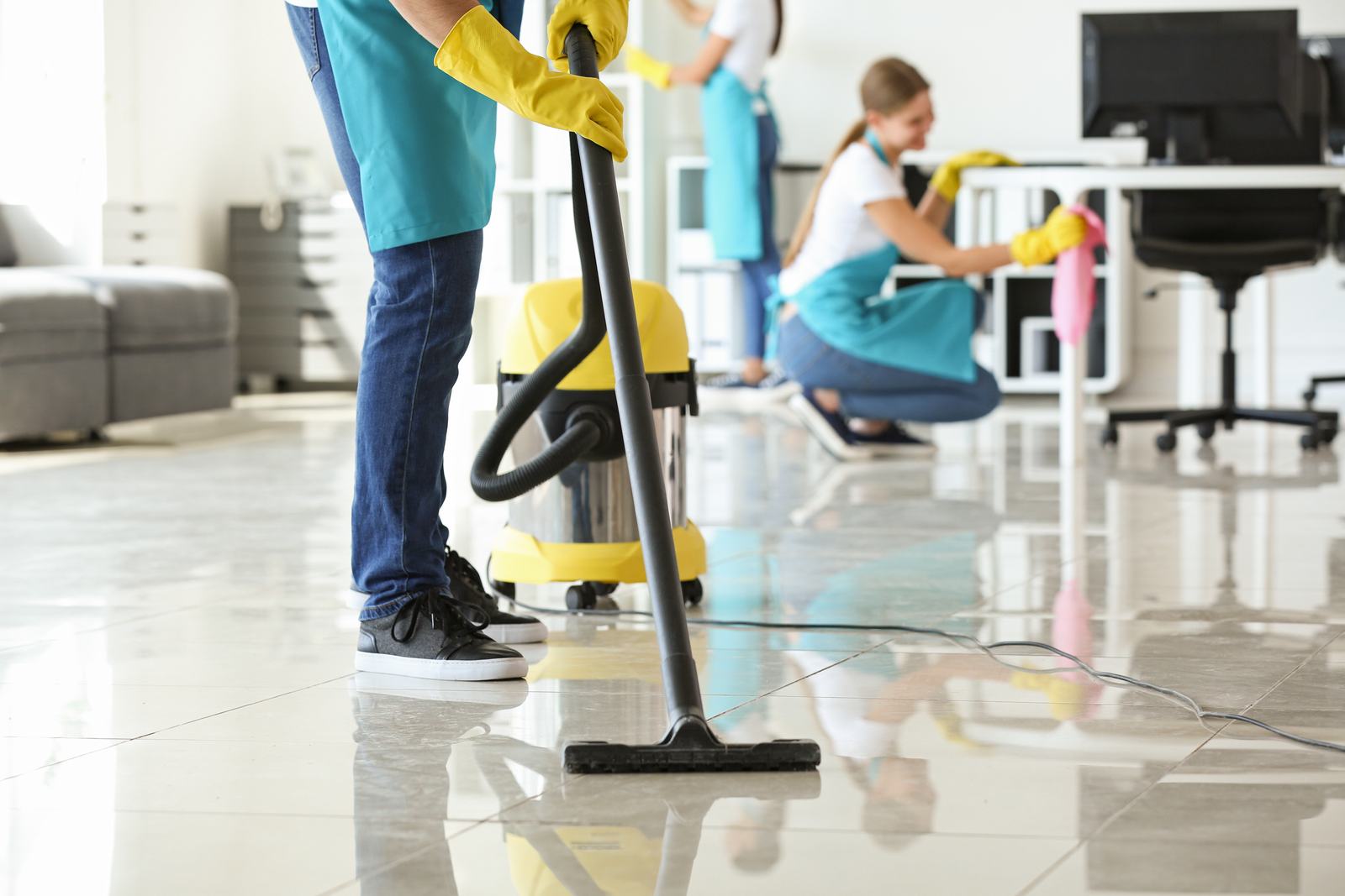 Crew vacuuming and dusting a shared workspace